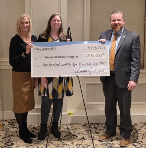 Linda Moore giving Dayton Childrens TWIG yearly pledge check